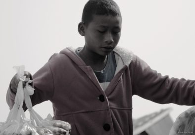 A young boy selling food on the boat to Bhamo